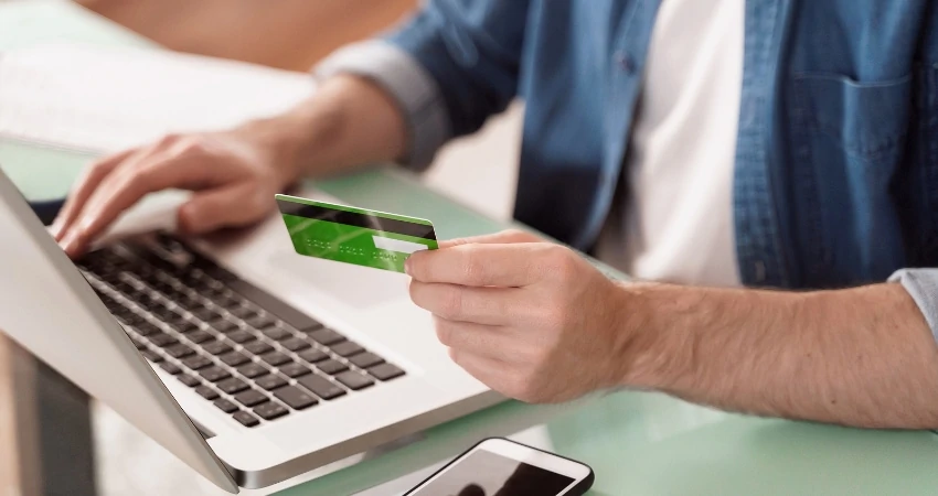 man entering his credit card information online