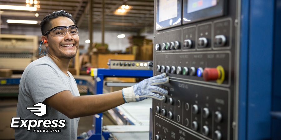 smiling man working machinery with Express Packaging logo