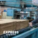 Man Feeding In Cardboard Boxes In Machine