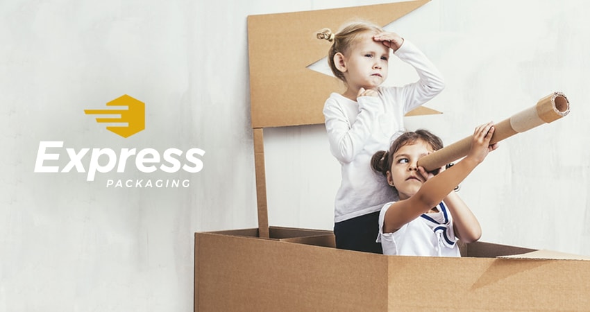 Two girls plating in cardboard fort with Express Packaging logo