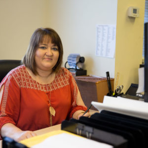 Office Manager at desk