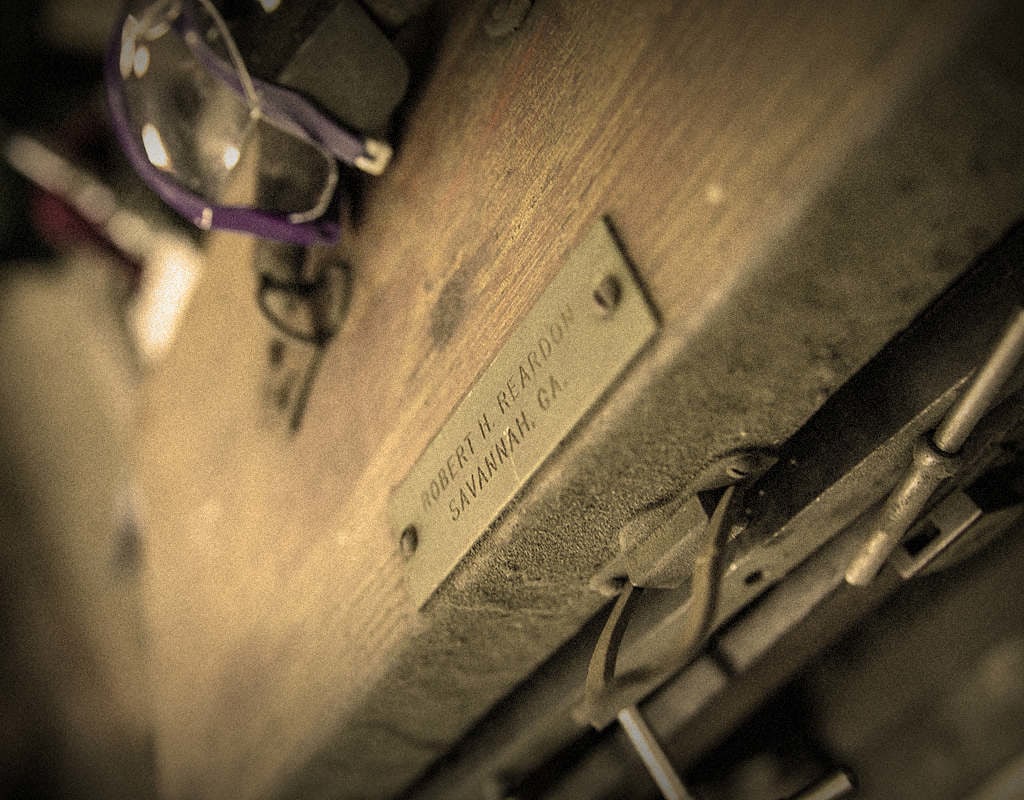 old name plate on dusty wooden surface