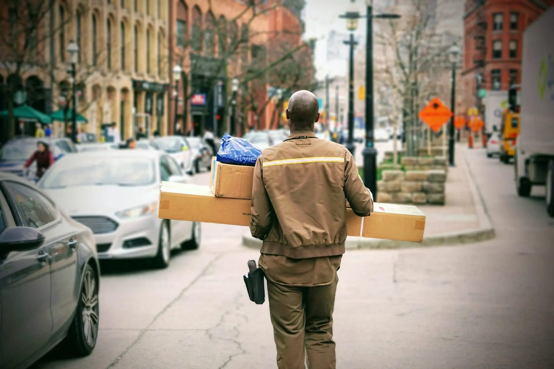 mailman carrying boxes in summer heat