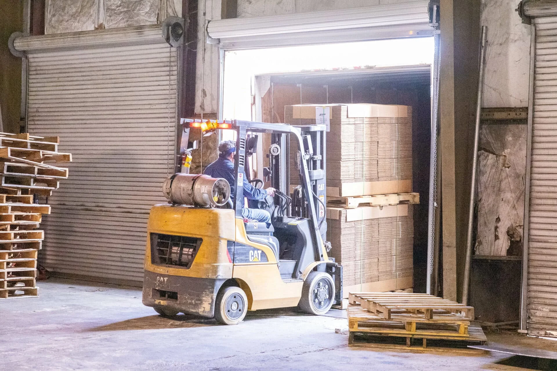 flattened boxes being loaded on shipping truck